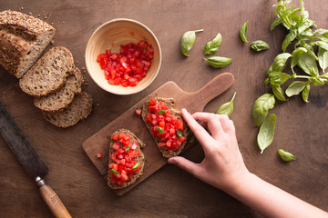 Hand holding Italian bruschetta