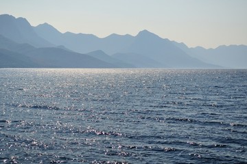 Sunlight emerging behind Biokovo mountain during morning