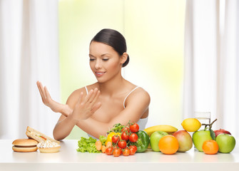 woman with fruits rejecting junk food