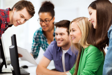 Obraz premium students looking at computer monitor at school
