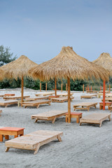 Fototapeta premium Many sunbeds on tropical beach.
