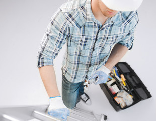 man with ladder, toolkit and spanner