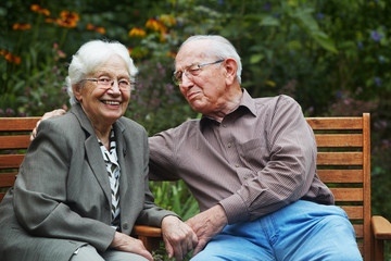 aged couple on the garden bench