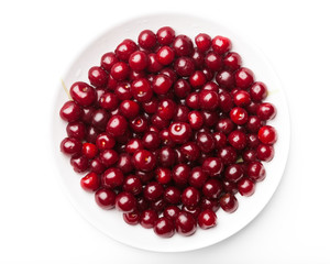 sour cherries on a plate, isolated on white