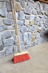 large broom on wall outdoor - housework