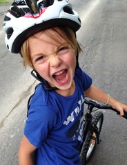 young boy with bicycle and helmet
