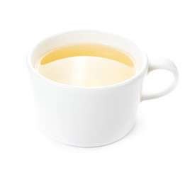 White cup of green organic tea on white background