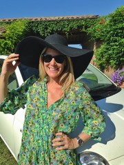 woman leaning on her car