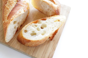 sliced baguette on wooden board,