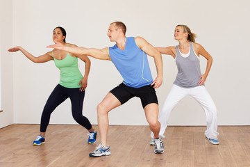 Fototapeta premium Group Of People Exercising In Dance Studio
