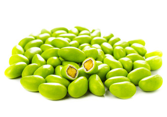 A pile of green gumballs with nuts isolated  on a white backgrou