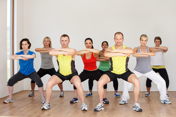 Fototapeta na wymiar Group Of People Exercising In Dance Studio