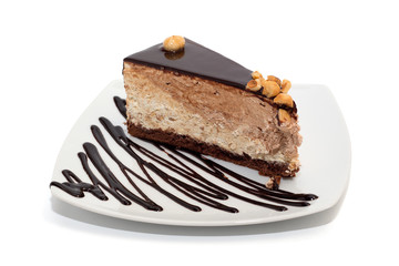 Nougat cake with chocolate, hazelnuts and topping isolated