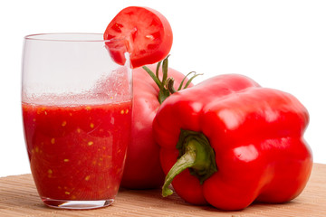 Tomato juice in a glass and vegetables