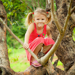 little girl sitting on the tree © altanaka