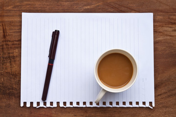 coffee with note and pen  on wood background