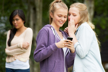 Teenage Girl Being Bullied By Text Message On Mobile Phone