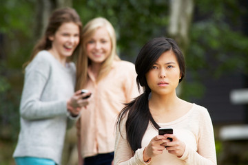 Teenage Girl Being Bullied By Text Message On Mobile Phone