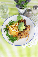Soup and rice with meat in plates on napkin on tablecloth