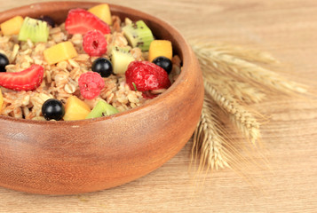 Oatmeal with fruits on table close-up