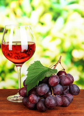 Ripe delicious grapes with glass of wine