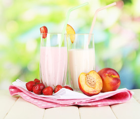 Delicious milk shakes with strawberries and peach