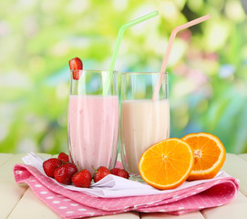 Delicious milk shakes with strawberries and orange