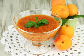 Apricot jam in glass bowl and fresh apricots,
