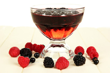 Jelly with fresh berries on wooden table