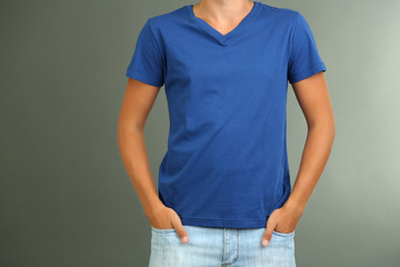 Obraz premium T-shirt on young man, on grey background