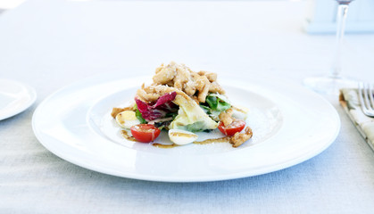 Caesar salad on white plate, close up