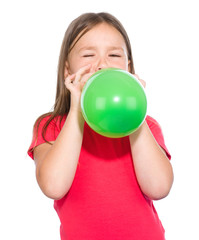 Little girl is inflating green balloon