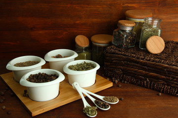 Assortment of spices in  white spoons and bowls,