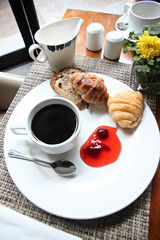 Hight view Coffee, bread and jam on a white plate.