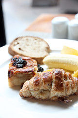 Zoom Banana bread sheet and toast in a white dish.