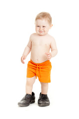 Little baby boy in father's shoes.