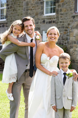 Bride And Groom With Bridesmaid And Page Boy At Wedding