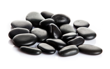 Black massage stones isolated.