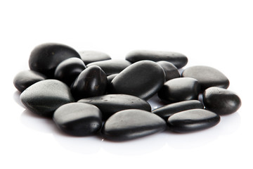 Black massage stones isolated.