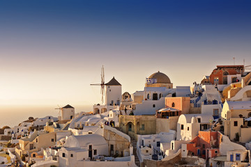 Oia white houses and windmills at sunset