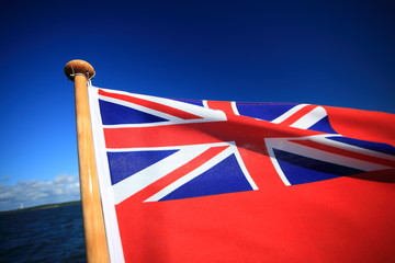 British maritime red ensign flag blue sky