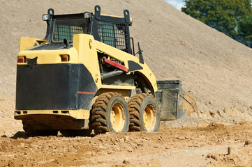 skid steer loader at earth moving works