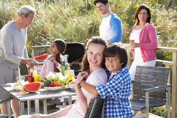 Multi Generation Family Having Outdoor Barbeque