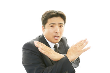 禁止の意思表示をするビジネスマン