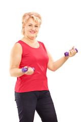 Mature smiling woman lifting up weights