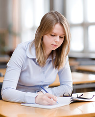 pretty young college student in a library