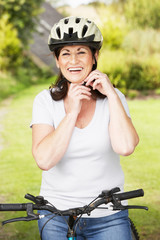 Mature Woman On Cycle Ride In Countryside