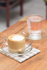 close up a cup of coffee on wooden table