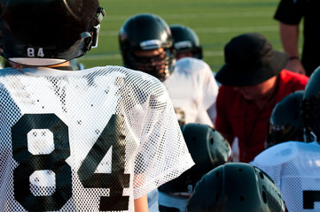 American football team in huddle
