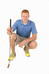 Young man with putter crouching